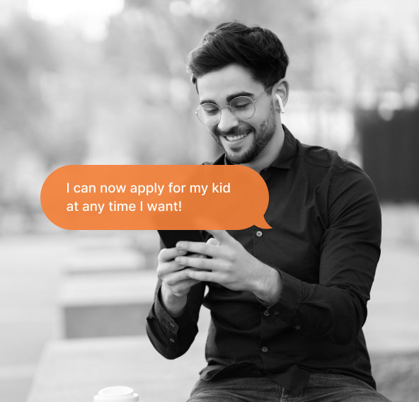 A man sitting on a bench looking at his phone screen