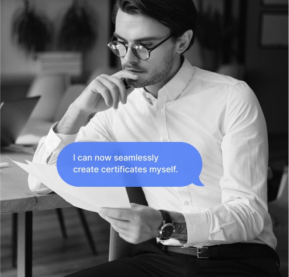 A working man sitting at a table looking at documents in hand