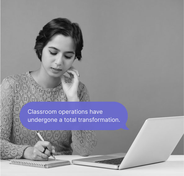 A woman taking notes with a laptop in front