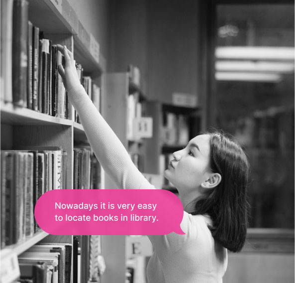A woman searching for a book from the top shelf of the library