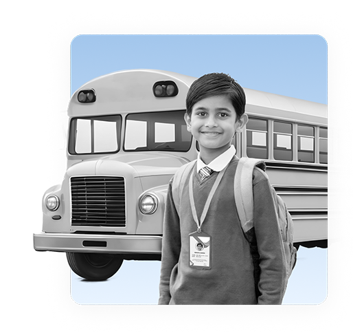 A student wearing an ID card standing in front of a school bus